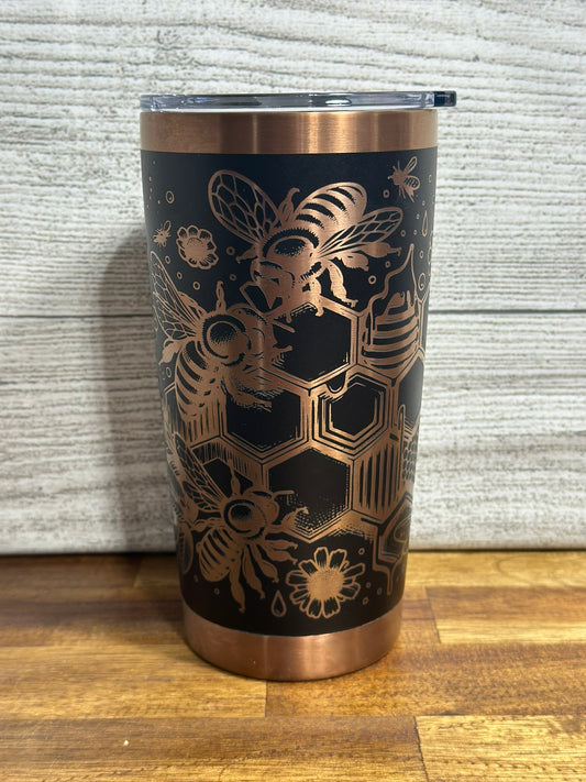 Custom designed bee tumbler with copper accents, featuring an intricate bee and honeycomb pattern.