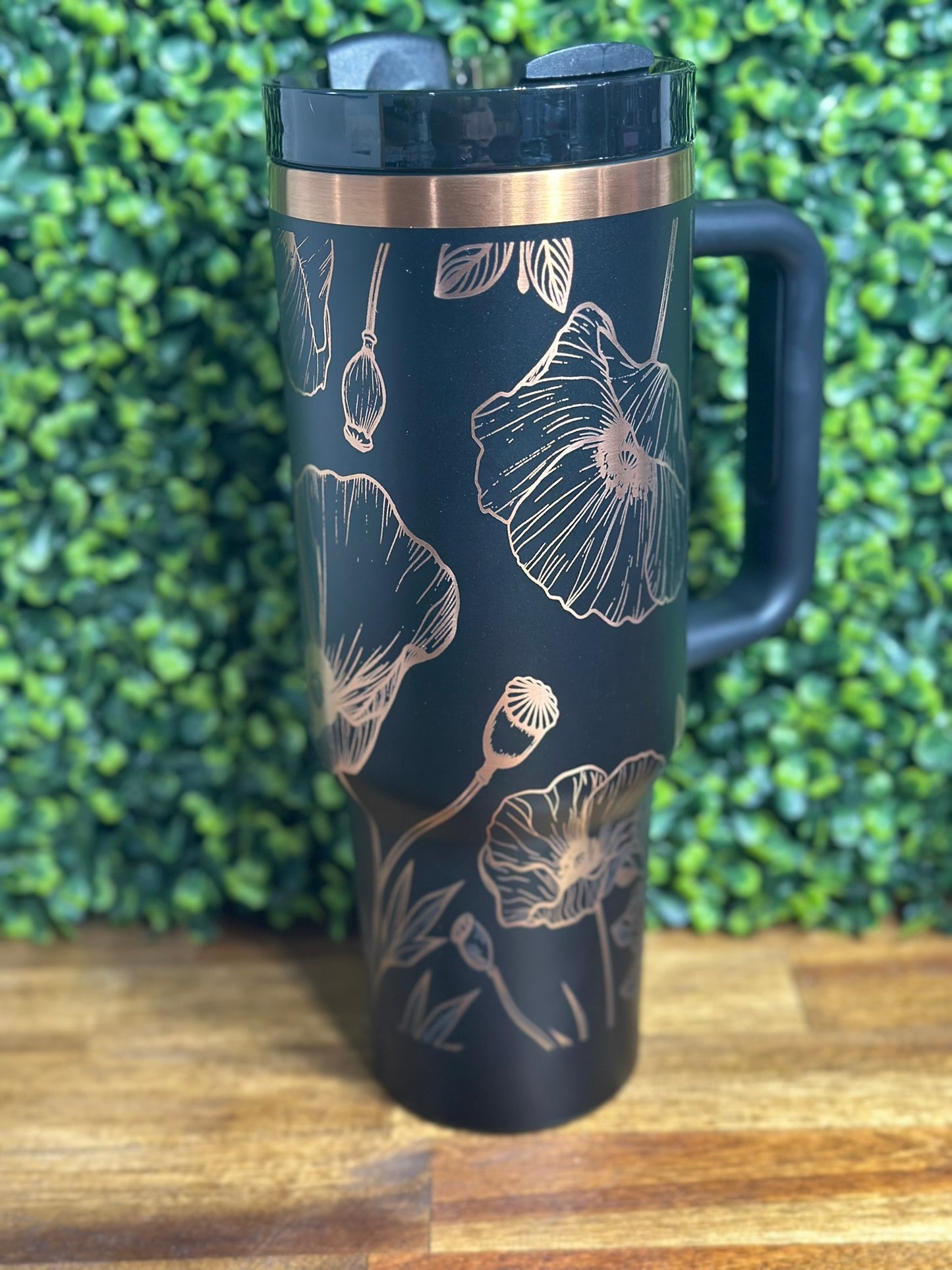 Custom designed Poppy tumbler with floral pattern in black and copper for hot and cold beverages.